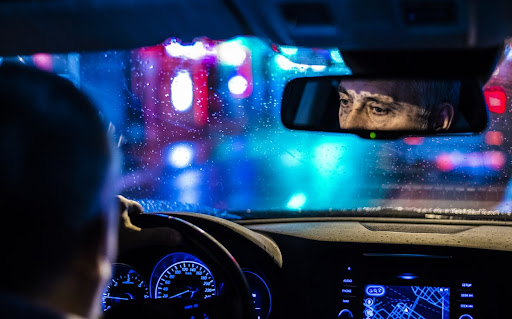 Image of rideshare driver driving through the night for an Uber accident statistics article.