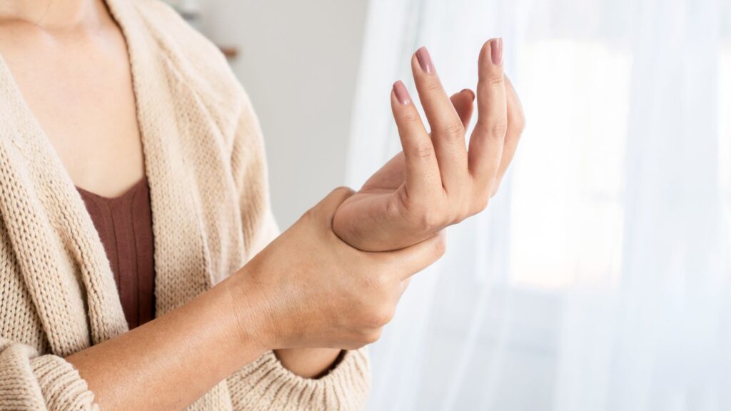Woman holding her wrist in pain.