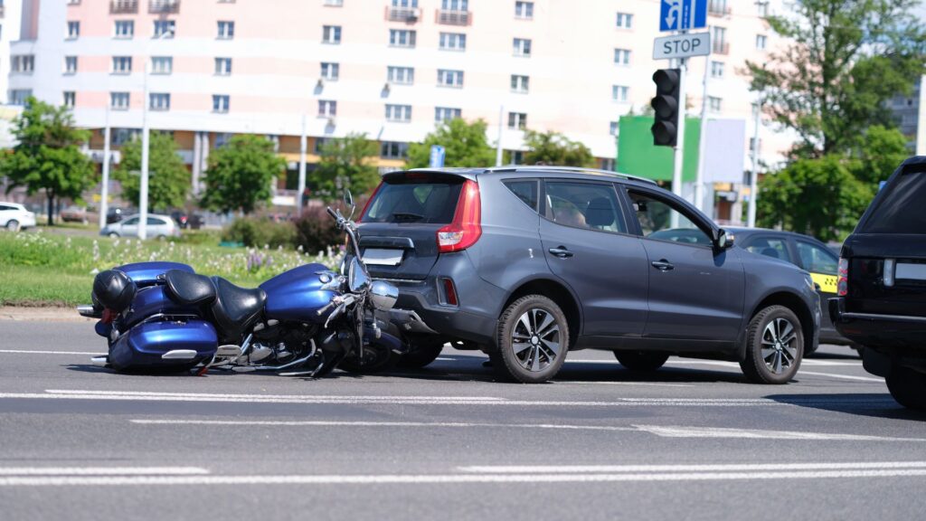 Vehicle accident involving a motorcycle rear-ending an SUV.