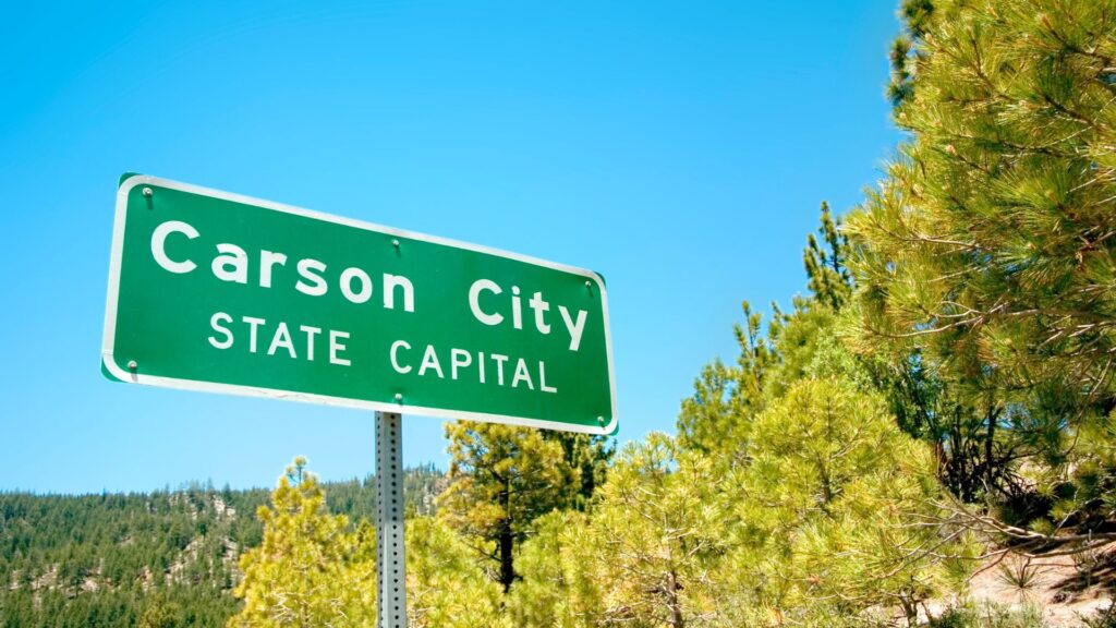 Green freeway sign reading "Carson City State Capital"