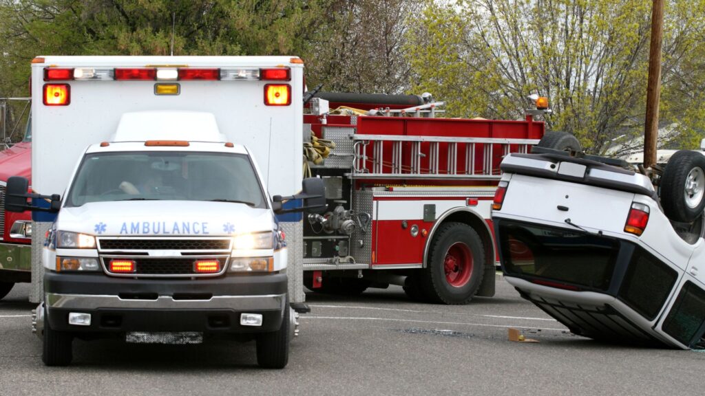 La escena de un accidente en Las Vegas, con una camioneta tumbada de lado y ambulancia.