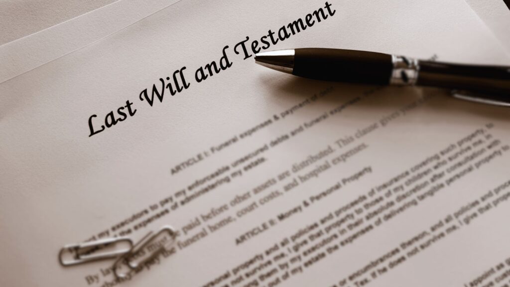 A pen on top of a will and testament document.